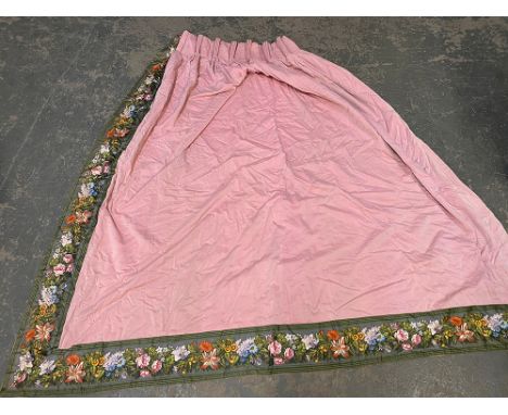 A pair of lined pink chintz curtains with green floral border, 225cm wide ungathered, 200cm drop 