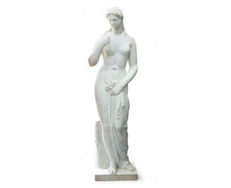 After the Antique. A large 19th century reconstituted marble figure of Venus, standing beside a tree trunk, 141cm high. Condi