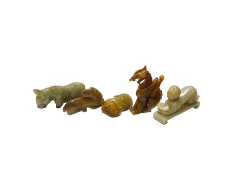 Four Chinese jade carvings, of a horse, cicada, a winged beast, a kneeling man, and a horned beast, longest 7cm. Condition - 
