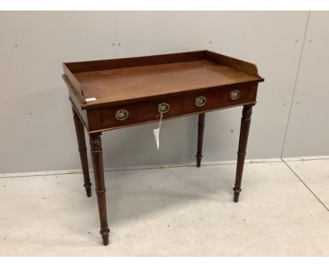 A Regency mahogany two drawer dressing table with a galleried top, on ring turned legs, width 91cm, depth 53cm, height 86cm. 