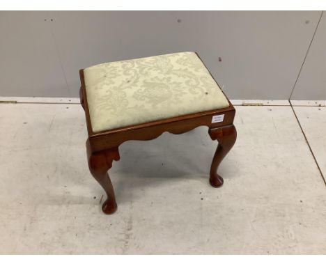 A Queen Anne style walnut dressing stool, with shaped frieze and cabriole legs, the drop in seat covered in silver fern cotto