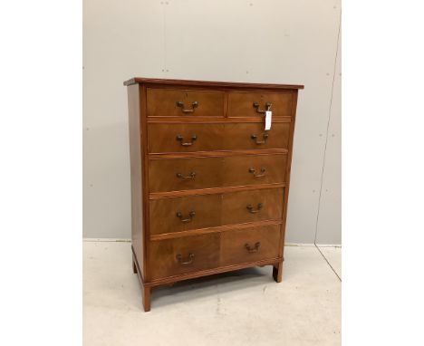 A George III style mahogany chest of two short and four long drawers, veneered fronts with brass loop handles, on bracket fee