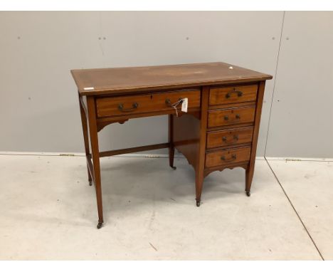 An Edwardian crossbanded mahogany kneehole desk, with moulded edge fitted one frieze drawer and four pedestal drawers, all wi