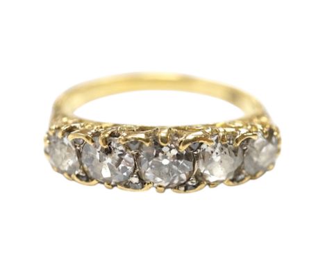 An early 20th century 18ct and graduated five stone diamond set half hoop ring, with rose cut diamond set spacers, size Q/R, 