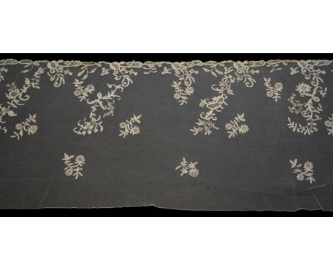 A 19th century five yard flounce of Brussels bobbin appliqué lace applied onto fine machine net, worked in a trailing floral 