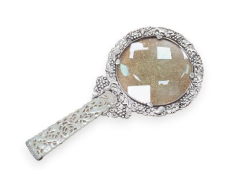A Chinese white metal and pale celadon jade handled magnifying glass, early 20th century, stamped ‘SILVER’, 19cm long. Condit