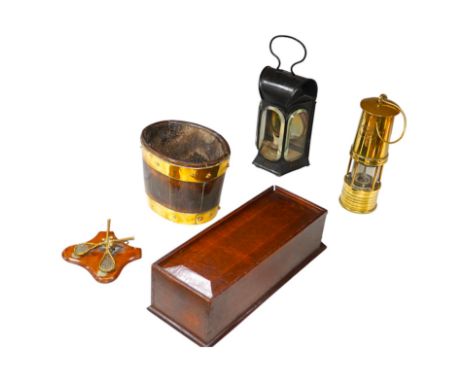 An early 19th century oak candlebox, an iron oil lamp, a brass miner’s lamp, a small brass bound coopered vessel and a paper 