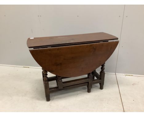 An 18th century oak gateleg table with an oval top on baluster turned under frame, 112cm extended, depth 100cm, height 68cm. 