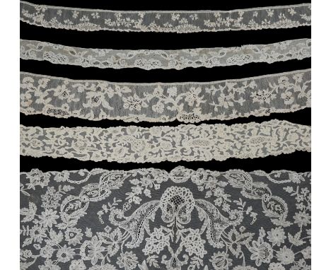 A large section of an ornate 19th century Brussels bobbin lace wedding veil, with two finished edges and one cut edge togethe
