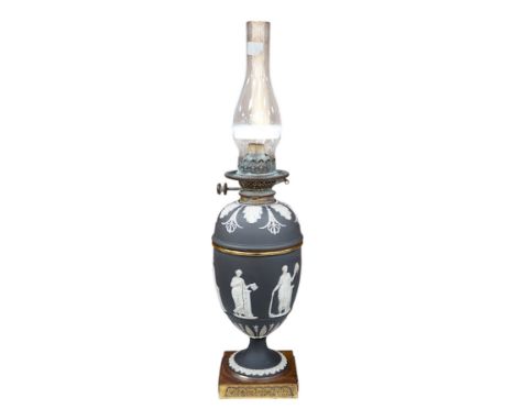 A Victorian black jasper oil lamp and reservoir, 65cm high. Condition - repaired at stem