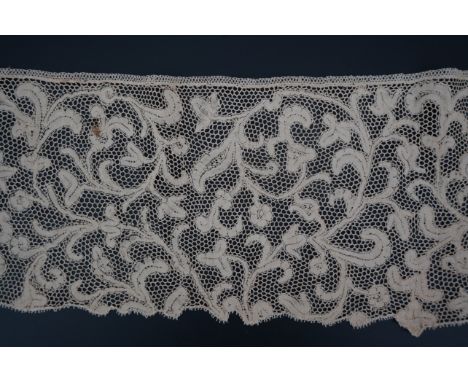A length of 1740-1760 Italian, Milanese bobbin lace flounce, made from flat braiding or tapes, placed into scrolling patterns