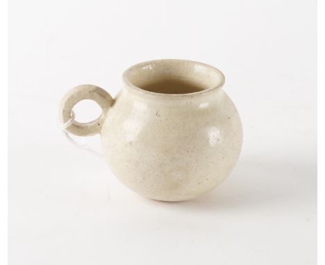 A CHINESE WHITE WARE CUPTang dynasty
Of bulbous form with short everted rim and loop handle, 6.5cm highThere is a circular pa