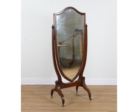 AN EDWARDIAN MAHOGANY FRAMED SHIELD SHAPED CHEVAL MIRROR77cm wide; 177cm highOld marks and scratches all over, both finials h