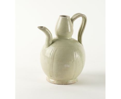 A CHINESE POTTERY EWERSong dynasty
Of gourd form with ribbed handle, the body incised with lines beneath a green-tinged glaze