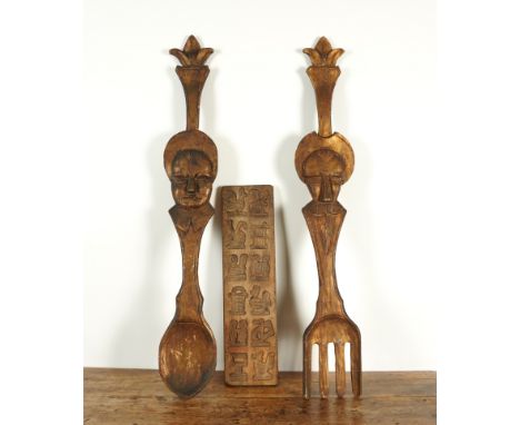 FOLK ART INTEREST: AN OVERSIZED CARVED GILT-WOOD SPOON AND FORK (5)99cm high 
Together with ginger bread biscuit mould, 55.5c