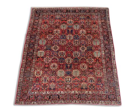 A BAKHTIARI CARPET, PERSIANThe tile field filled with floral designs; the black border with bold palmettes and trailing flowe