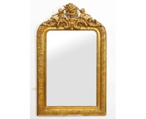 A VICTORIAN GILT FRAMED WALL MIRROR WITH CHERUB MOUNTED CREST (2)65cm wide; 107cm high and a later oval gilt decorated mirror