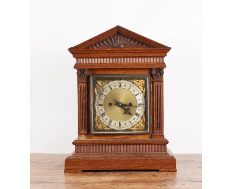 AN OAK CASED MANTLE CLOCKLate 19th Century
The 5 1/2 inch brass dial with silvered chapter ring and Roman numerals, decorated