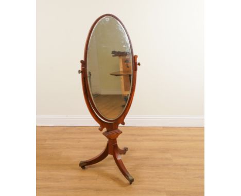 AN EDWARDIAN MAHOGANY OVAL CHEVAL MIRROR ON TRIPOD BASE68cm wide; 150cm high
