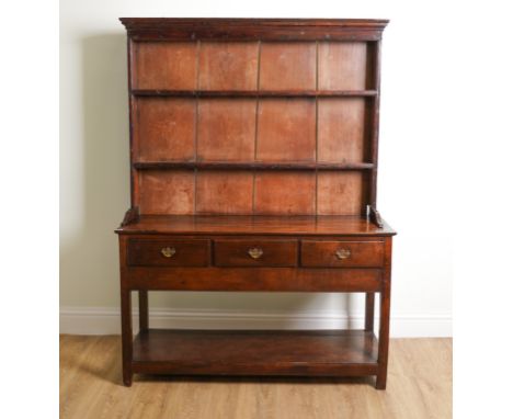 AN 18TH CENTURY OAK DRESSERWith a three tier plate rack 130cm wide; 41cm deep; 178cm highLarge chip to the top left corner of