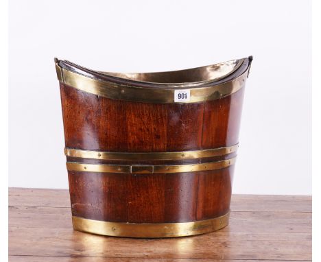 A GEORGE III BRASS BOUND MAHOGANY NAVETTE SHAPED BUCKET42cm wide; 25cm deep; 30cm highProvenanceThe collection of the lateCou
