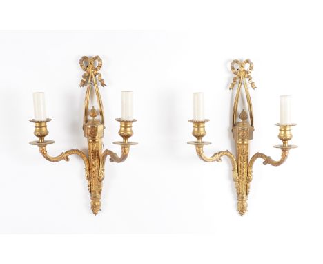A PAIR OF LOUIS XVI STYLE GILT-METAL TWIN LIGHT WALL APPLIQUÉS AND ANOTHER SET OF FOUR (6)Early 20th Century 
With laurel lea