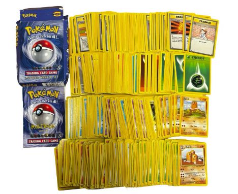 A large collection of 1990s WOTC Pokemon Base Set Trading Cards and original starter set box and manual.Played condition