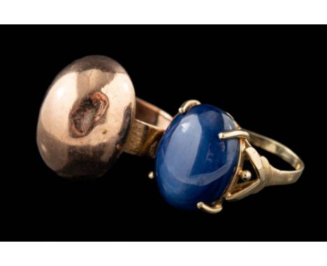 A synthetic star sapphire ring,: the oval cabochon synthetic star sapphire in a four claw setting, stamped 14k, ring size L; 