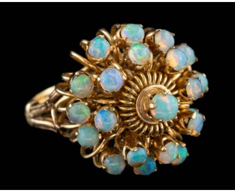 An opal dress ring,: set with a cluster of circular cut opals, stamped 18k, ring size K.