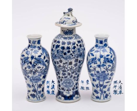 A pair of Chinese blue and white 'dragon' vases and one similar with cover: each painted with opposing dragons amongst flower