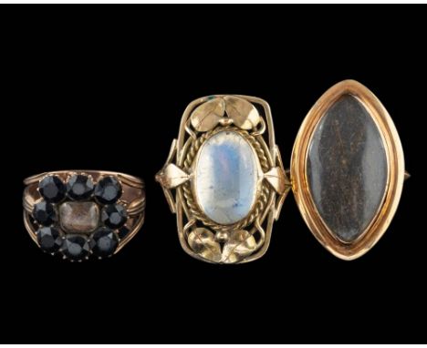 A moonstone ring,: the oval cabochon moonstone collet set within a ropetwist surround accented with leaves, ring size Q; and 