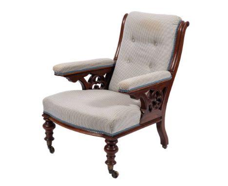 A Victorian mahogany and button upholstered library armchair, in Gothic taste, mid 19th century,: the straight armrests on tr