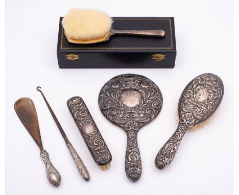 A mixed lot of silver wares, various makers and dates: includes hair brushes, hand mirror, clothes brush, silver handled butt