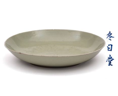 A Chinese anhua-decorated celadon deep dish: incised overall with scrolling lotus plants and stems under a pale celadon glaze
