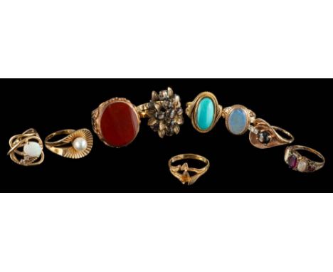 A group of eight gem set rings,: including an opal and diamond ring; a carnelian ring; and six further rings.
