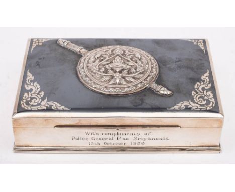 A Chinese sterling silver niello enamel and wood cigarette casket: inscribed, of rectangular outline, the hinged lid with rou