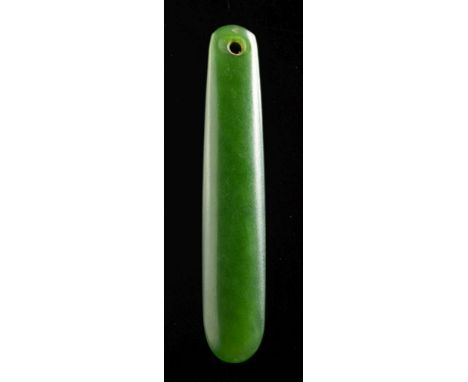 A Maori jade pendant (Kuru): of slender rectangular form with pierced end, 6.5cm long.