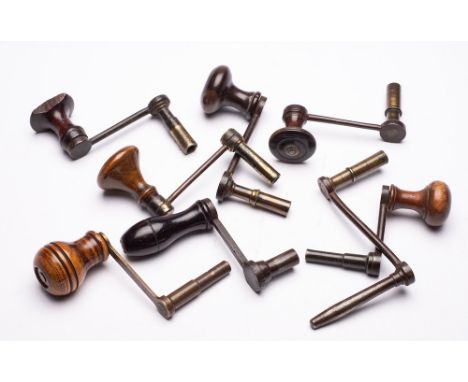 Eight longcase clock winding keys: of crank form with wooden handles.