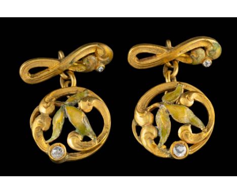 A pair of enamel and diamond cufflinks,: the enamelled openwork foliate panels set with a rose cut diamond, stamped K18, 2cm 