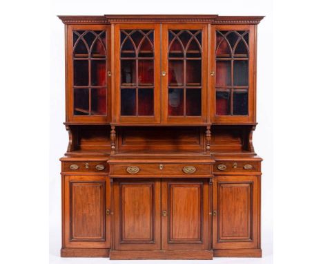 A mahogany and glazed breakfront cabinet bookcase in 19th century style,: with ogee moulded and dentilled cornice, above a pa