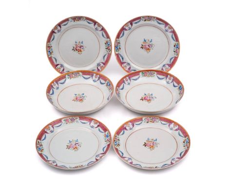 A set of four Chinese famille rose dishes and a pair of matching deep dishes: each painted with a central floral spray within