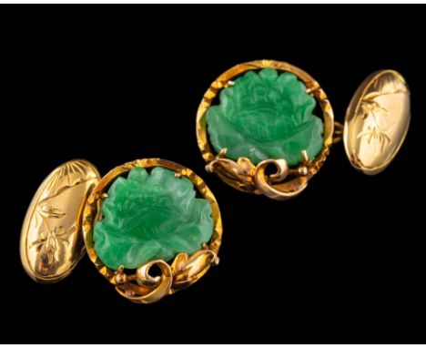 A pair of jade cufflinks,: the carved lotus jade panels within decorative surrounds, 1.7cm diameter.