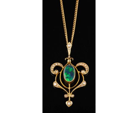 An Edwardian boulder opal doublet and seed pearl pendant,: circa 1905, the oval boulder opal collet set within an openwork sc