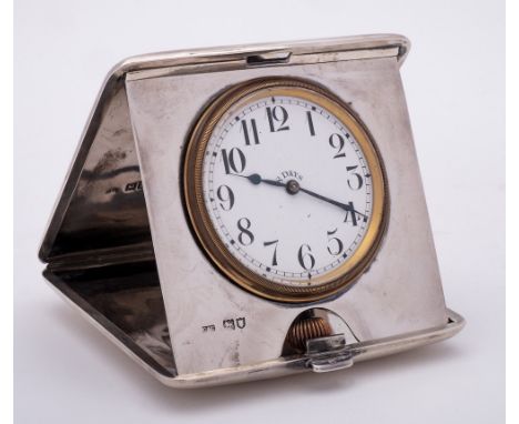 A George V silver cased travelling timepiece, maker Cohen & Charles, London, 1912: of square outline, the hinged case enclosi