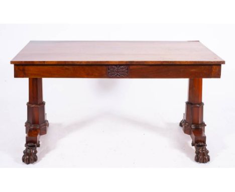 A George IV mahogany library table, circa 1825,: with rectangular top, the front and back each with a central acanthus carved