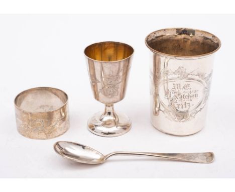 A German silver christening set, stamped marks: includes cup, spoon and napkin ring, with engraved foliate decoration, cased,