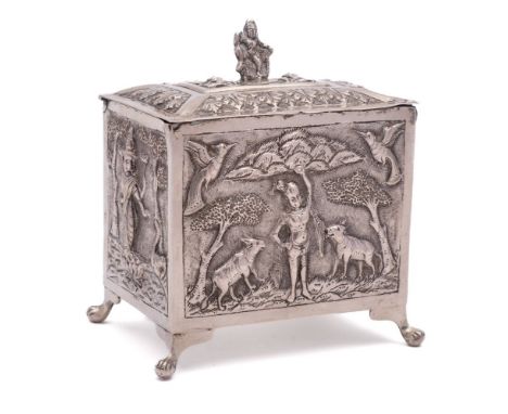 An Indian silver tea caddy: of rectangular outline, with shallow domed hinged lid, the side panels decorated with deities and