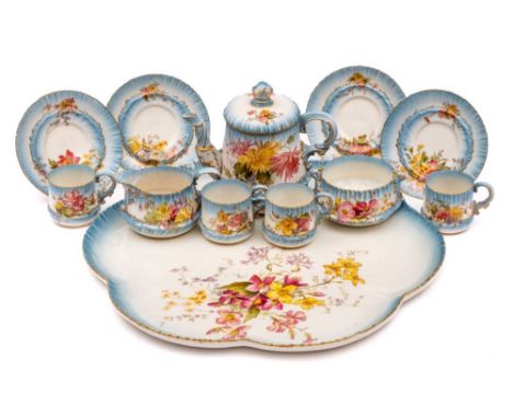 A Royal Worcester porcelain cabaret set: comprising a teapot and cover, sugar bowl, milk jug, four cups and four saucers and 