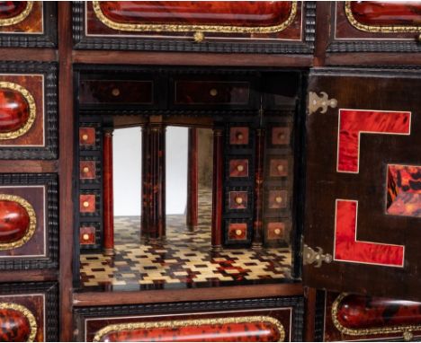 A 19th Century Flemish simulated scarlet tortoiseshell, ebony and ivory inlaid architectural cabinet on a stand:, bordered wi