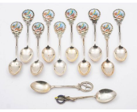 A matched set of ten silver and enamel teaspoons, various makers and dates: initialled, the terminals with budgerigar  decora